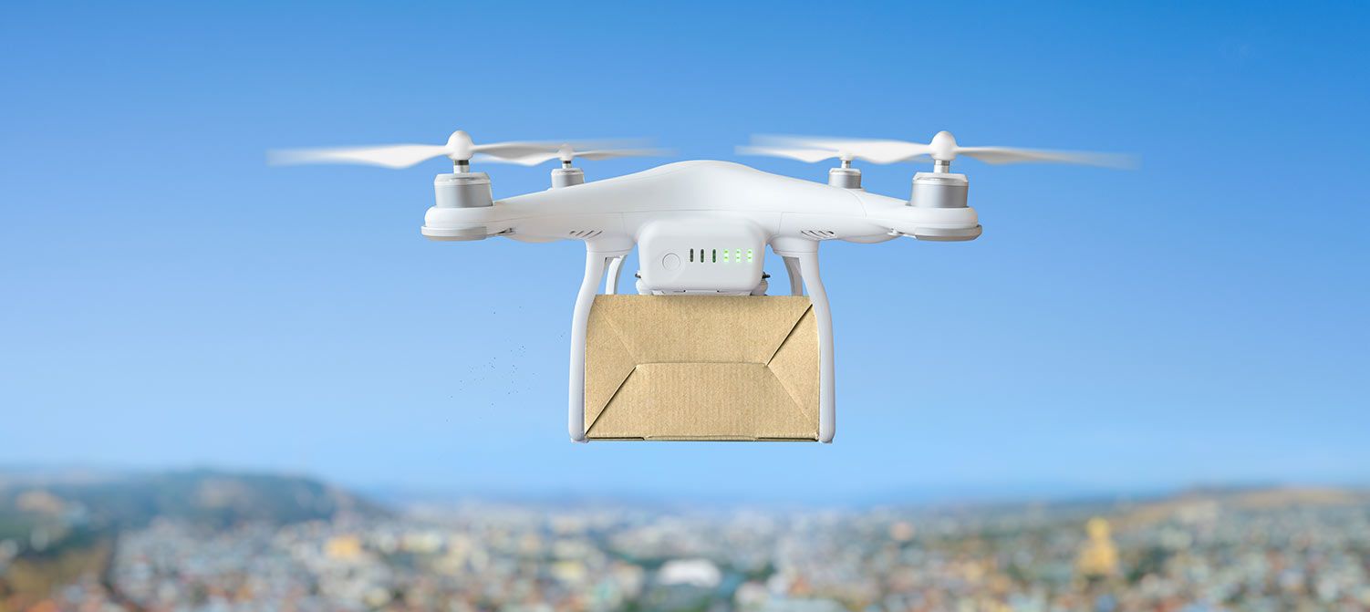 Image of drone delivering box