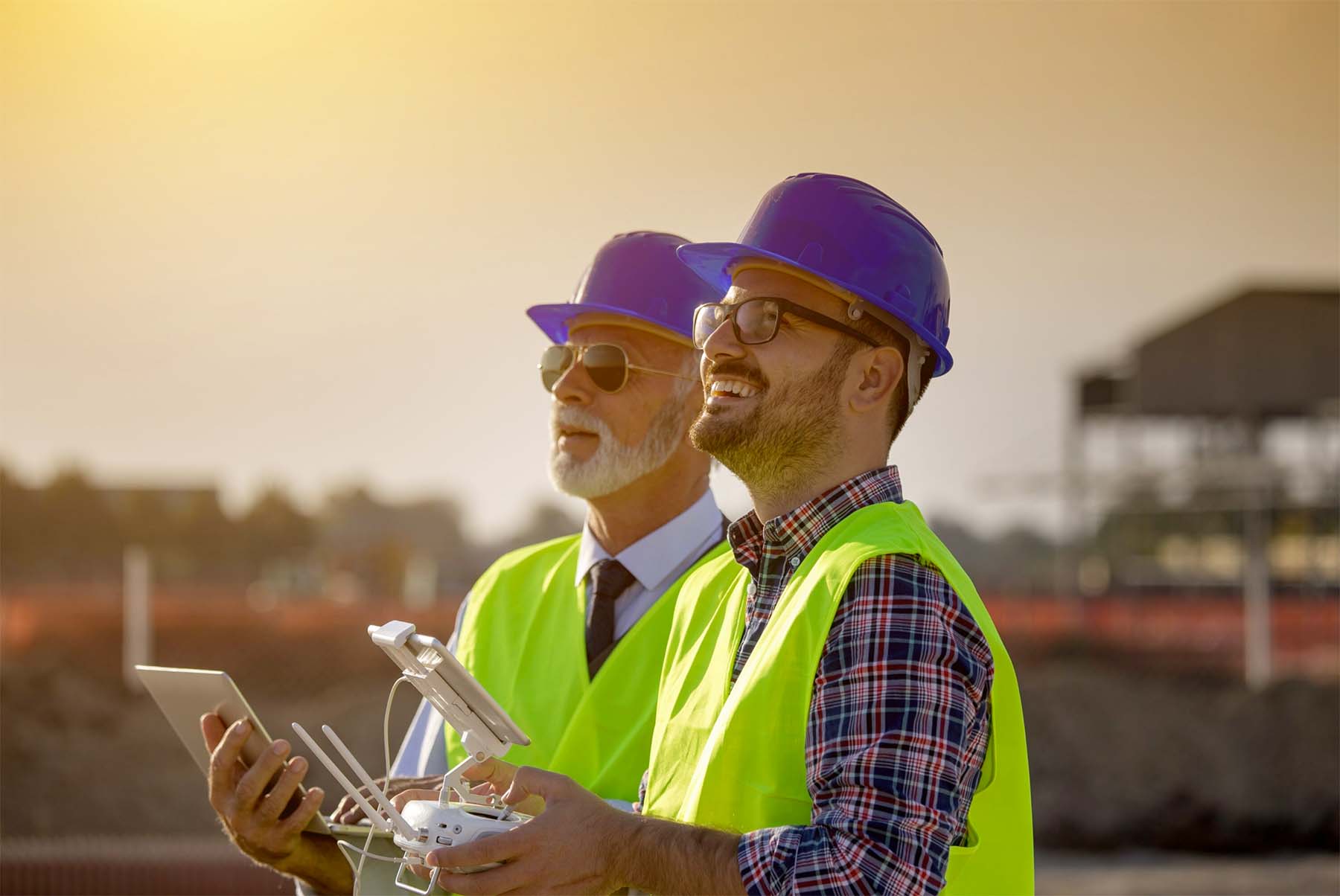 Photo of construction workers flying drones